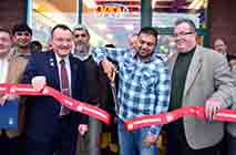 Owner Tahir Sial, center, with Pete Bardunias, left, of the Chamber of Southern Saratoga County and Halfmoon Supervisor Kevin Tollison, cuts the ribbon Friday, Dec. 20, 2013, to open of the Halal Meat Market on Route 9 in Halfmoon, N.Y. Halal Meat Market is the first such store in the Clifton Park area. | Image credit: John Carl D'Annibale / Times Union